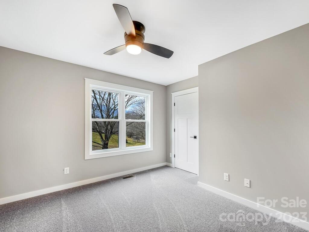 921 Newfound Road Leicester, NC 28748 - Photo 19 of 28 an empty room with a window