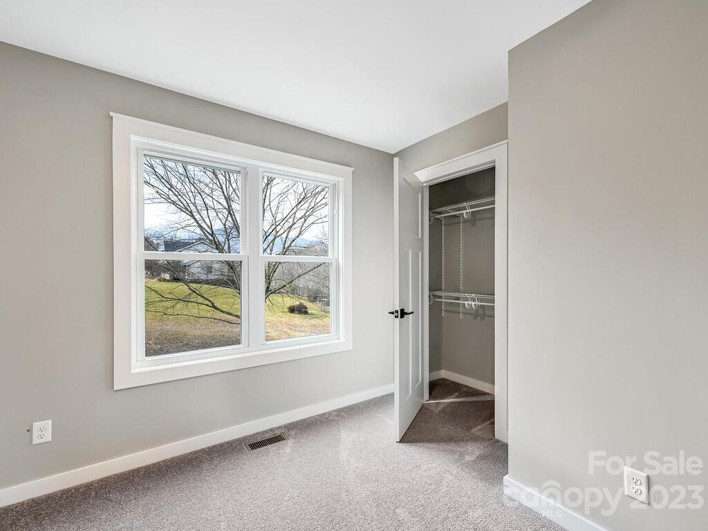 921 Newfound Road Leicester, NC 28748 - Photo 20 of 28 an empty room with windows view and closet