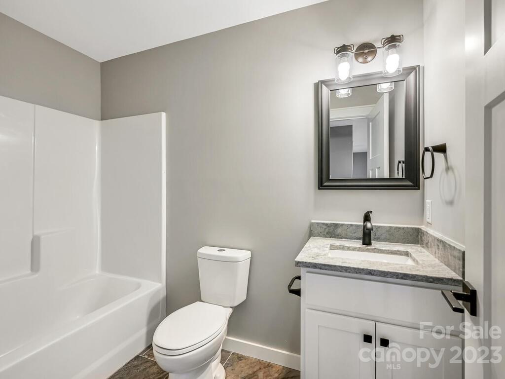 921 Newfound Road Leicester, NC 28748 - Photo 23 of 28 a bathroom with a toilet a sink and bathtub