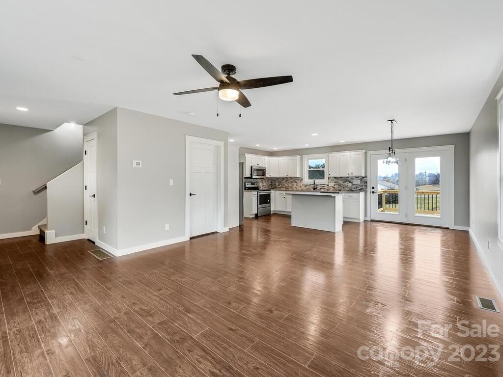 921 Newfound Road Leicester, NC 28748 - Photo 9 of 28 a view of an empty room with kitchen and window