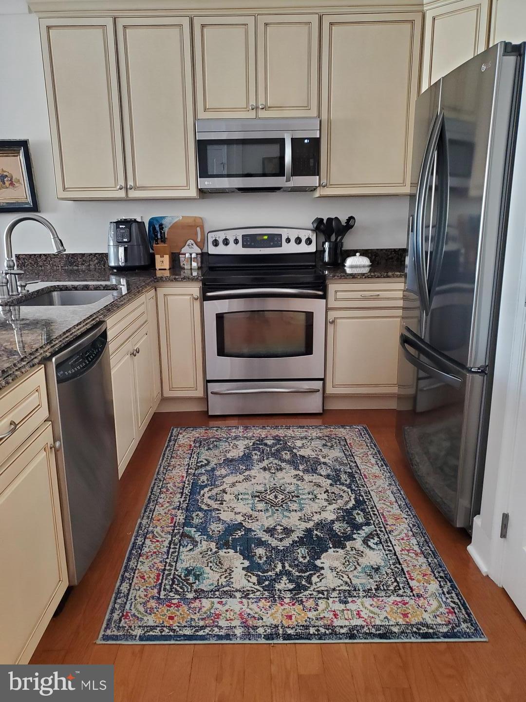 17432 Slipper Shell Way Lewes, DE 19958 - Photo 2 of 12 a kitchen with a stove top oven and refrigerator