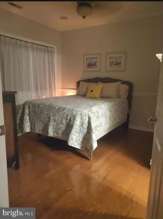 a bedroom with a bed and a night stand