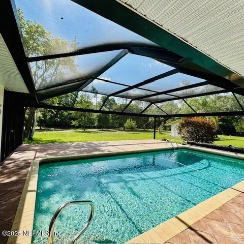 a view of a swimming pool with a yard