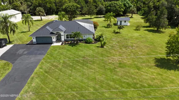 a aerial view of a house with swimming pool and next to yard