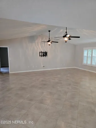 a view of a room with a ceiling fan