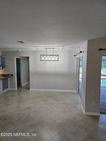 an empty room with closet and windows