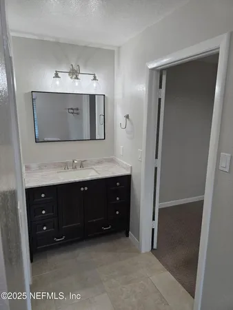a bathroom with a double vanity sink and mirror