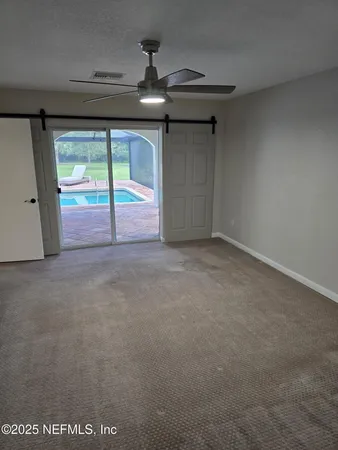 a view of empty room with sliding door