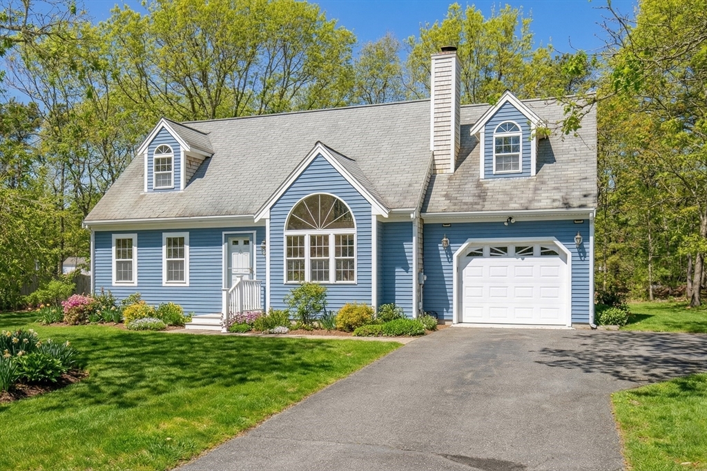 10 Butler Lane Mashpee, MA 02649 - Photo 1 of 42 a front view of a house with a yard and garage