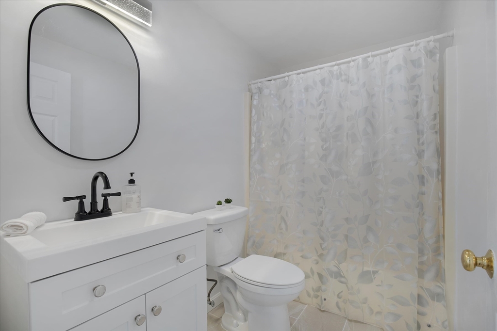 10 Butler Lane Mashpee, MA 02649 - Photo 12 of 42 a bathroom with a toilet sink and mirror