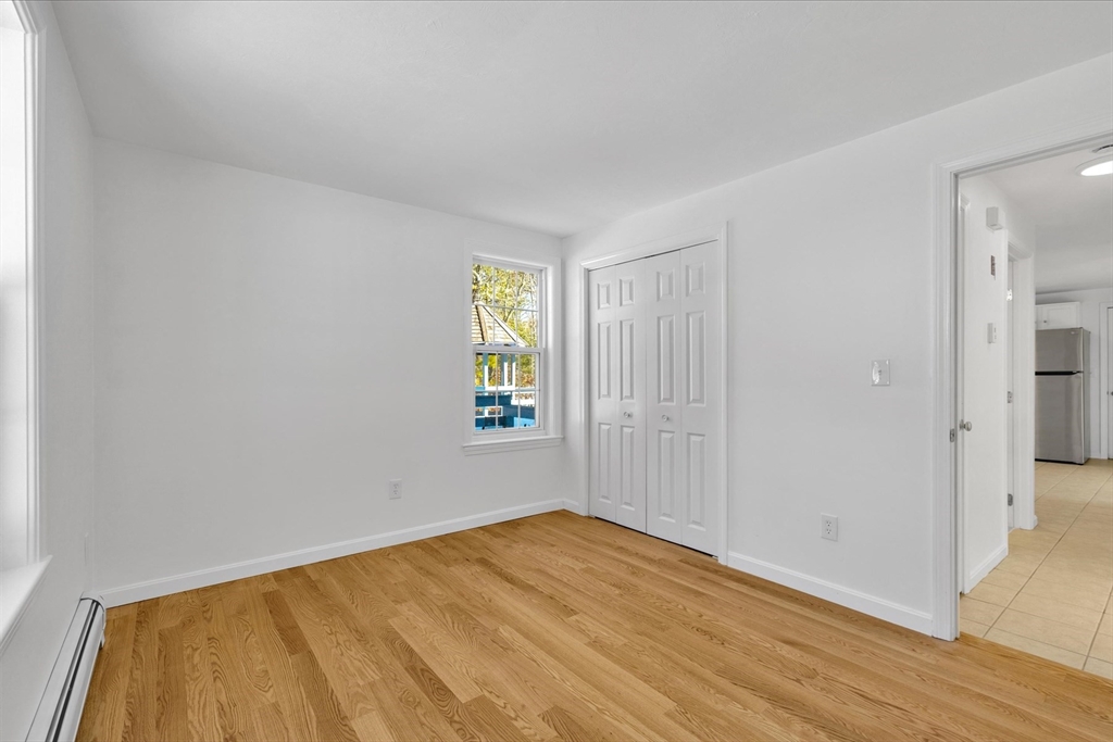 10 Butler Lane Mashpee, MA 02649 - Photo 14 of 42 a view of empty room with window and wooden floor
