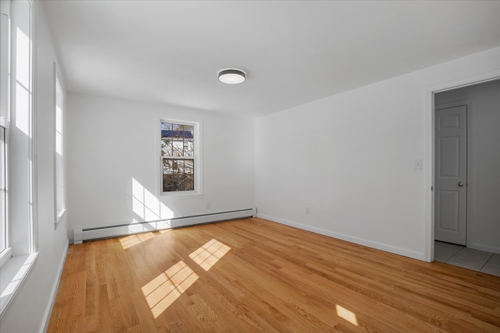 10 Butler Lane Mashpee, MA 02649 - Photo 16 of 42 an empty room with wooden floor and windows