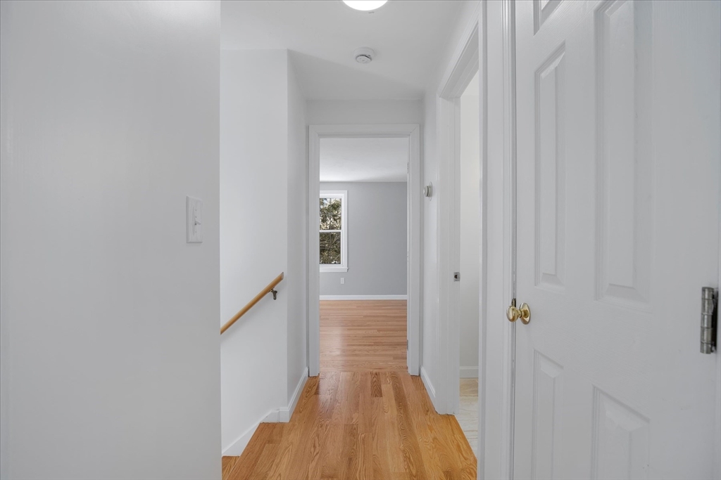 10 Butler Lane Mashpee, MA 02649 - Photo 20 of 42 a view of a hallway with wooden floor and staircase