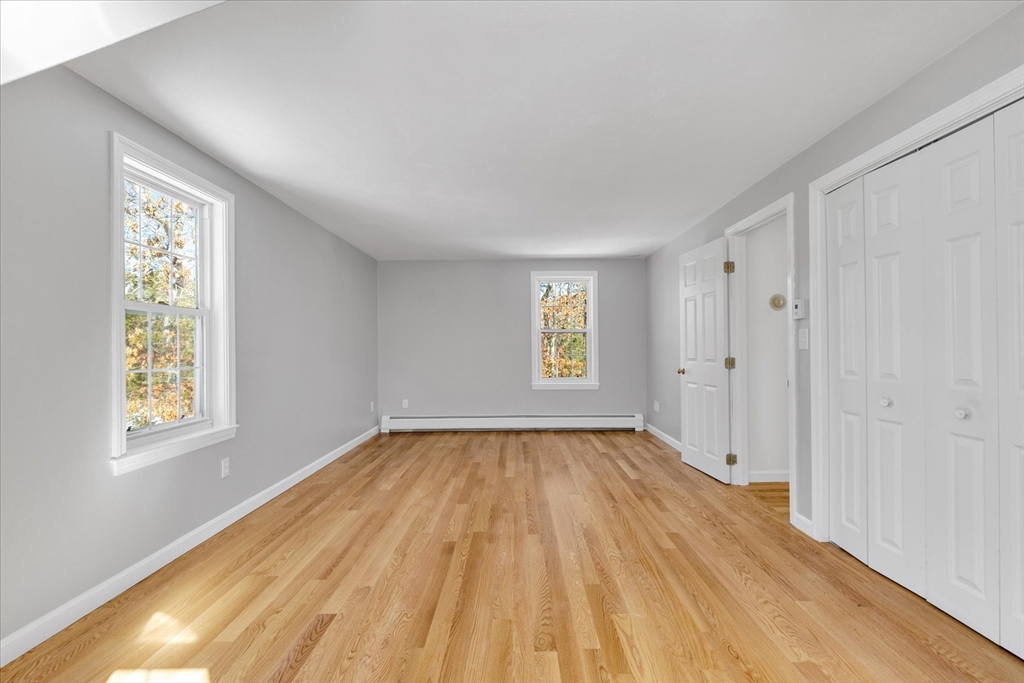 10 Butler Lane Mashpee, MA 02649 - Photo 25 of 42 a view of an empty room with wooden floor and a window