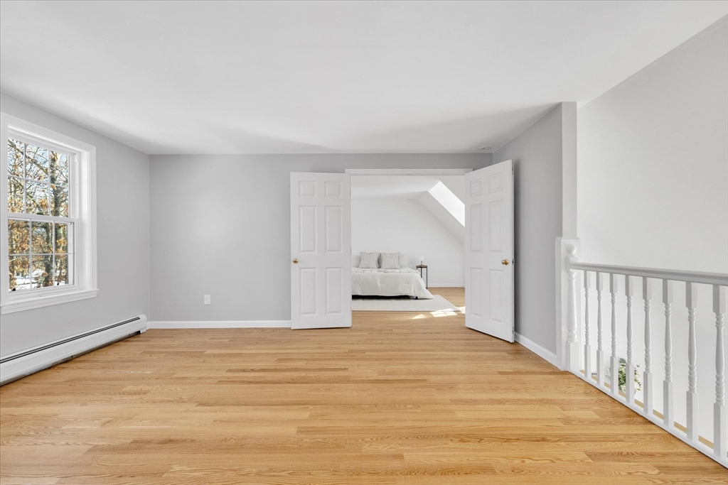 10 Butler Lane Mashpee, MA 02649 - Photo 27 of 42 a view of an empty room with wooden floor and a window