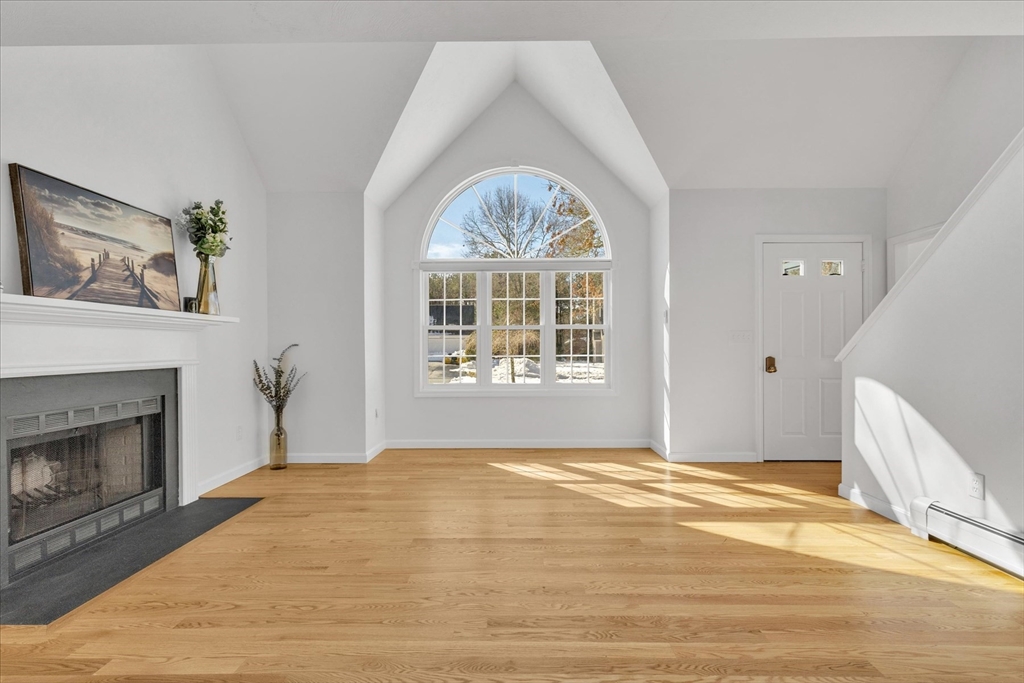 10 Butler Lane Mashpee, MA 02649 - Photo 5 of 42 a view of an empty room with a fireplace and a window