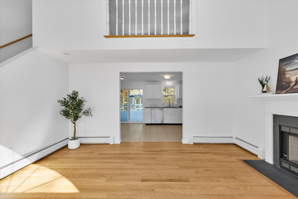 10 Butler Lane Mashpee, MA 02649 - Photo 6 of 42 a view of a room with wooden floor and a potted plant