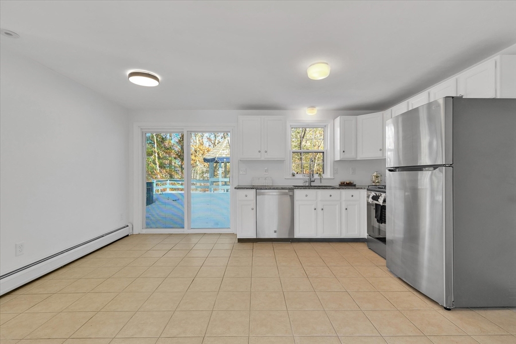 10 Butler Lane Mashpee, MA 02649 - Photo 7 of 42 a kitchen with a refrigerator a stove top oven and a refrigerator