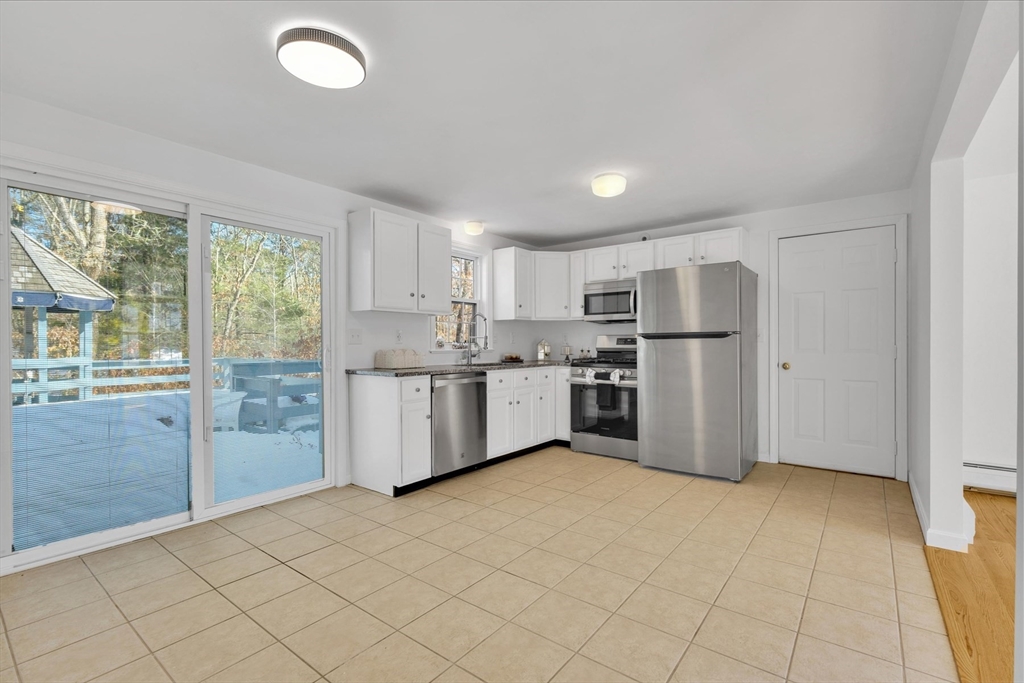 10 Butler Lane Mashpee, MA 02649 - Photo 8 of 42 a kitchen with a refrigerator a sink and cabinets