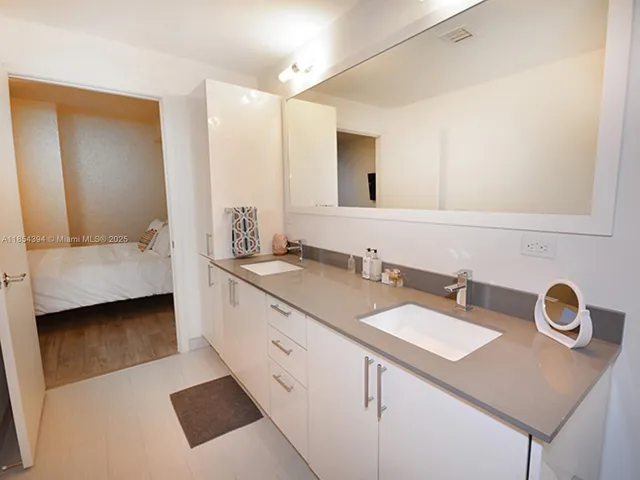 a large bed sitting in a bedroom next to a cabinet