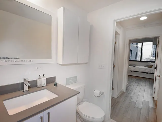 a refrigerator with white cabinets