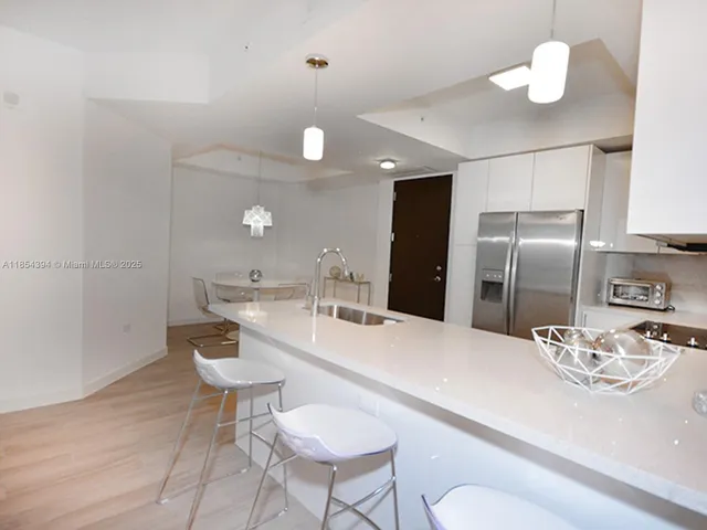 a kitchen with stainless steel appliances a sink a stove and microwave