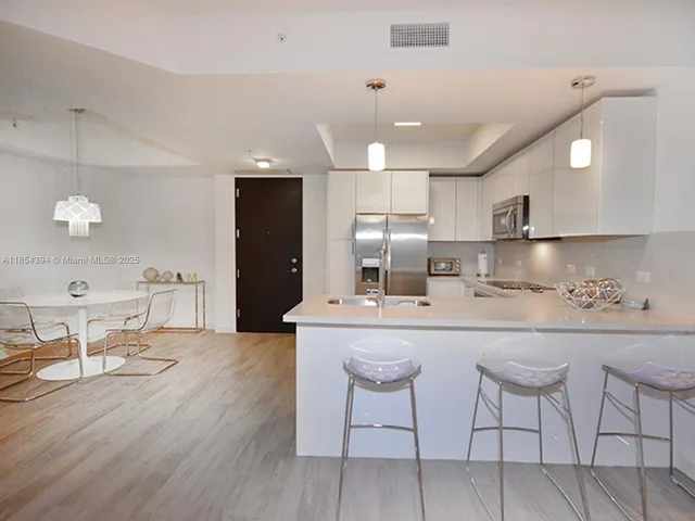 a kitchen with a refrigerator stove and microwave