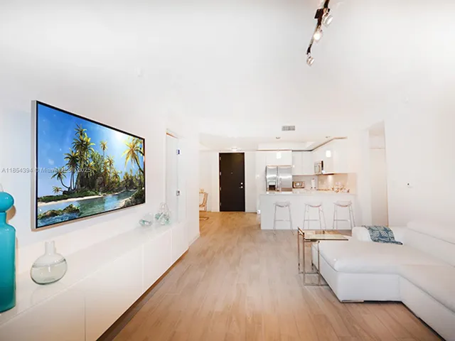 a living room with a flat screen tv and a floor to ceiling window