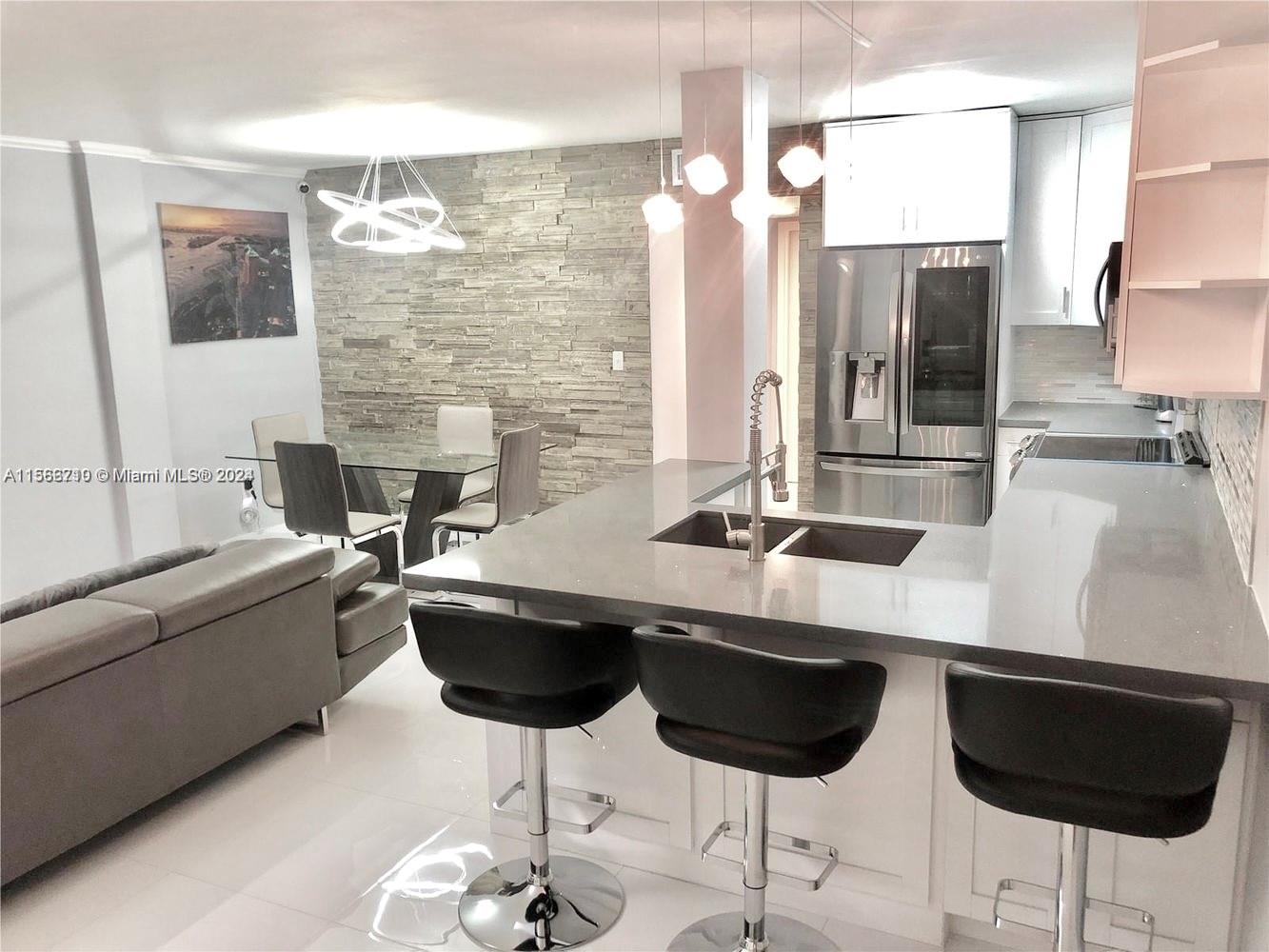 a kitchen with a table chairs sink and granite counter top