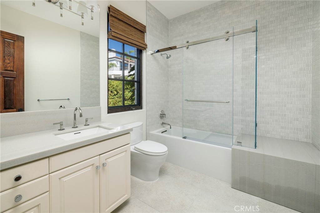 6 Premiere Point Newport Coast, CA 92657 - Photo 32 of 36 a bathroom with a double vanity sink toilet mirror and shower
