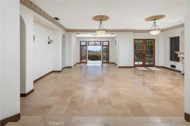 a view of an empty room with fireplace and a window