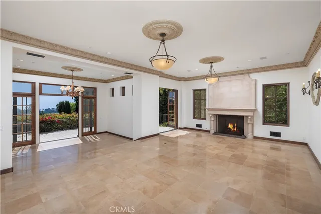 a view of a room with a chandelier and glass door