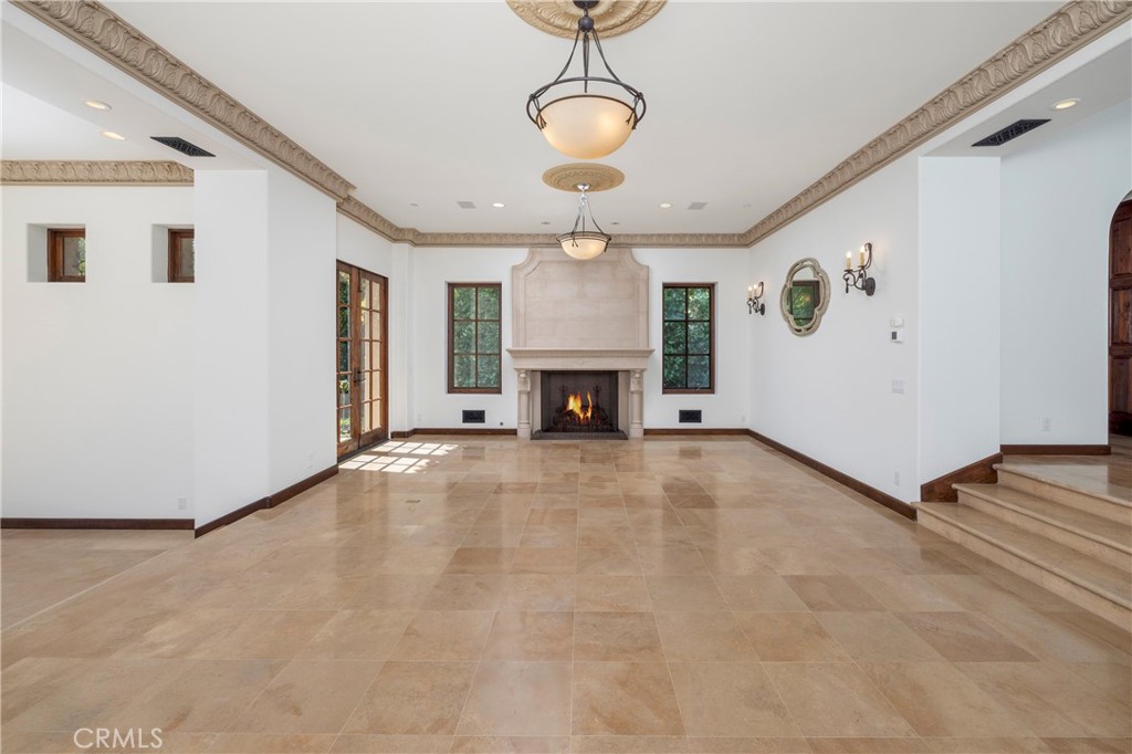 6 Premiere Point Newport Coast, CA 92657 - Photo 9 of 36 a view of a livingroom with a fireplace a chandelier and windows