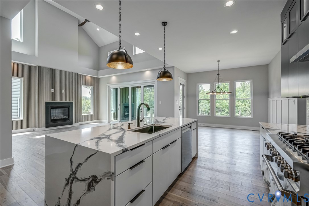 3519 Ampfield Way Midlothian, VA 23112 - Photo 4 of 18 a open kitchen with stainless steel appliances granite countertop a sink a stove and a wooden floors