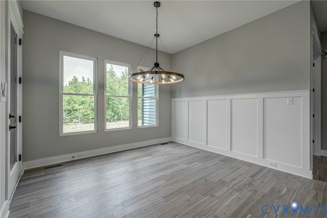 3519 Ampfield Way Midlothian, VA 23112 - Photo 7 of 18 a view of an empty room with a window and wooden floor