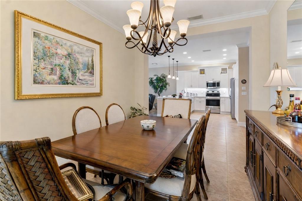 4339 Aurora Street Naples, FL 34119 - Photo 15 of 47 a view of a dining room and kitchen island with furniture