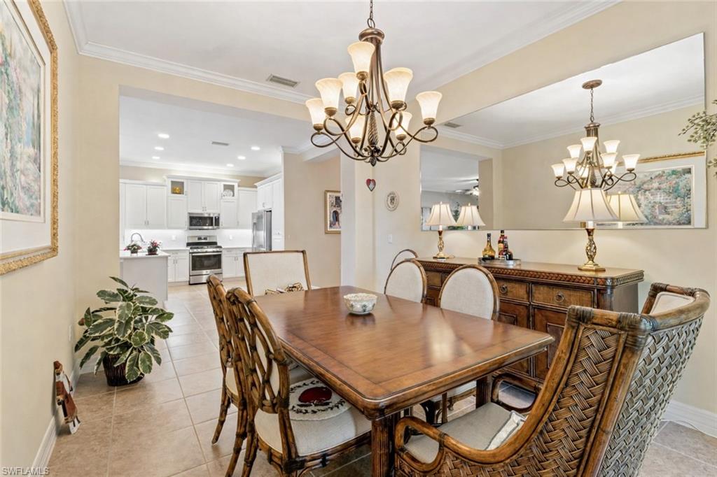 4339 Aurora Street Naples, FL 34119 - Photo 17 of 47 a view of a dining room with furniture and chandelier