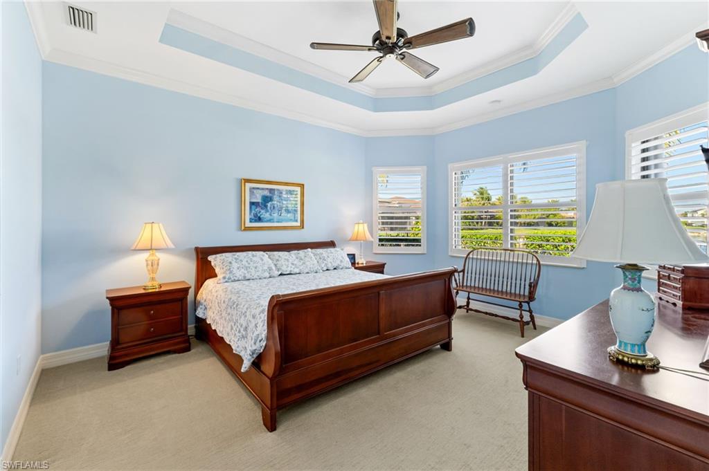 4339 Aurora Street Naples, FL 34119 - Photo 18 of 47 a spacious bedroom with a bed and a window