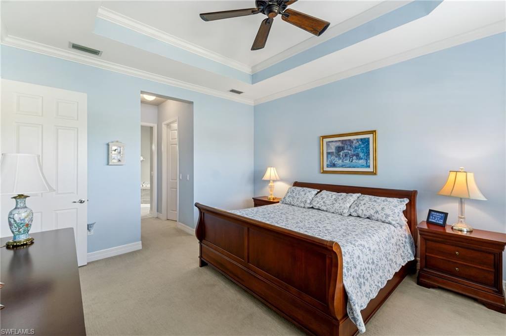 4339 Aurora Street Naples, FL 34119 - Photo 19 of 47 a bedroom with a bed and a chandelier