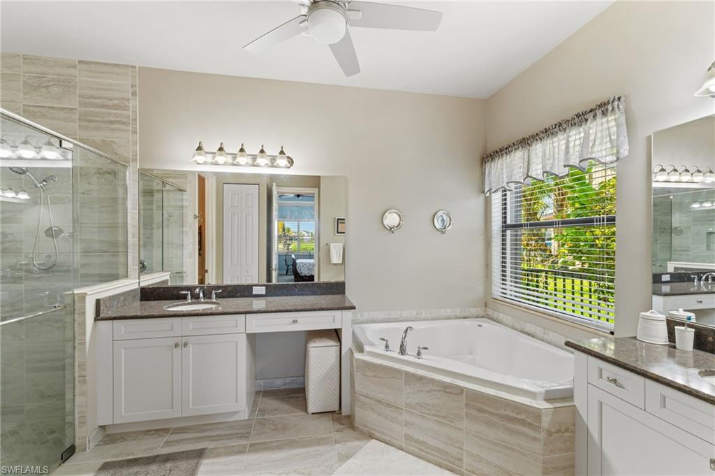 4339 Aurora Street Naples, FL 34119 - Photo 20 of 47 Primary bath features separate tub and shower and vanities