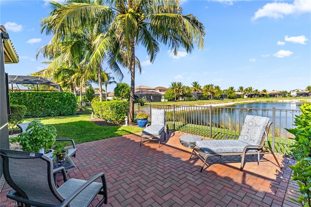 4339 Aurora Street Naples, FL 34119 - Photo 2 of 47 a view of a lake with a table and chairs