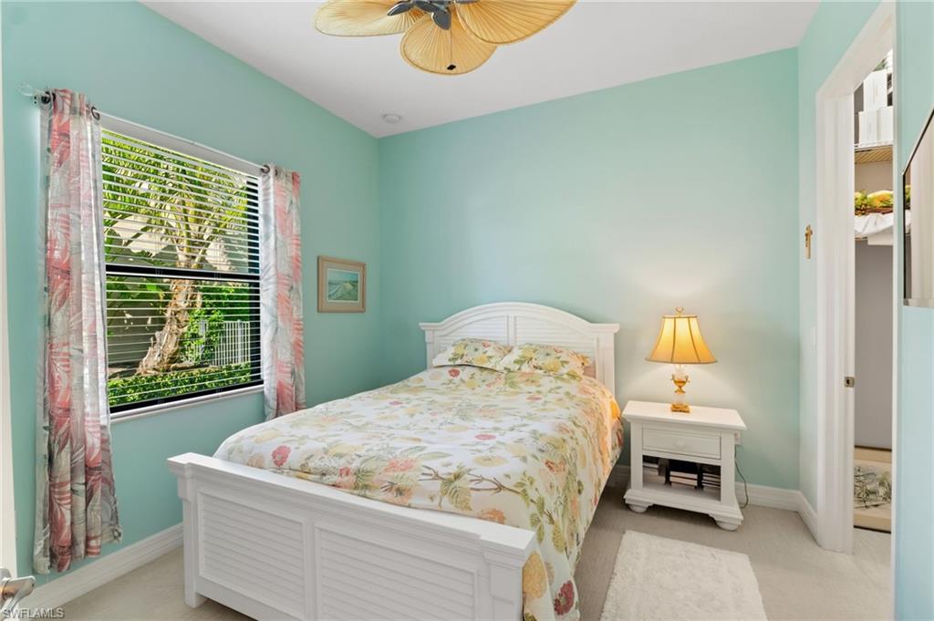 4339 Aurora Street Naples, FL 34119 - Photo 22 of 47 a bedroom with a bed and window