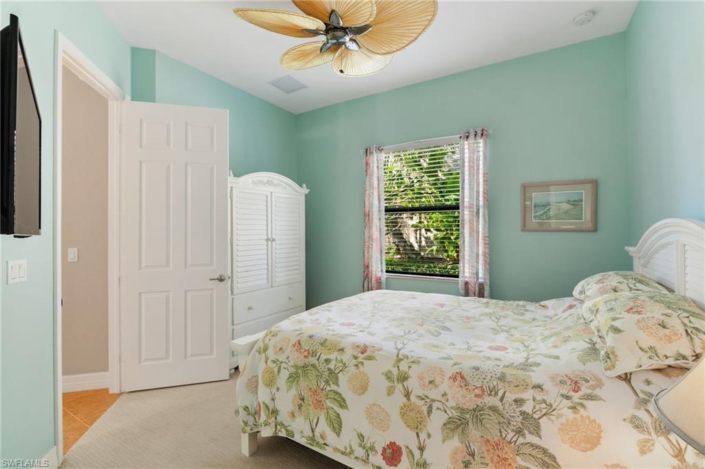 4339 Aurora Street Naples, FL 34119 - Photo 23 of 47 a bedroom with a bed and a window