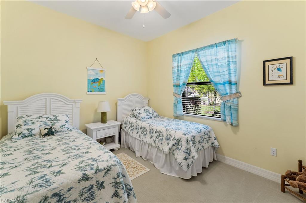 4339 Aurora Street Naples, FL 34119 - Photo 25 of 47 a bedroom with two beds and a window