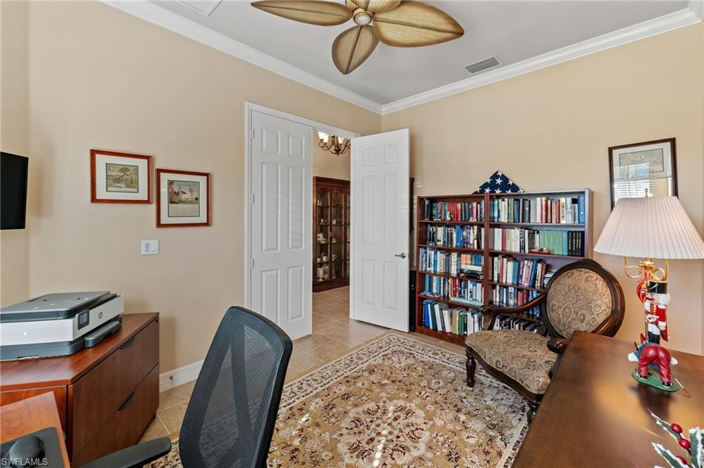 4339 Aurora Street Naples, FL 34119 - Photo 28 of 47 a workspace with furniture bookshelf and a window