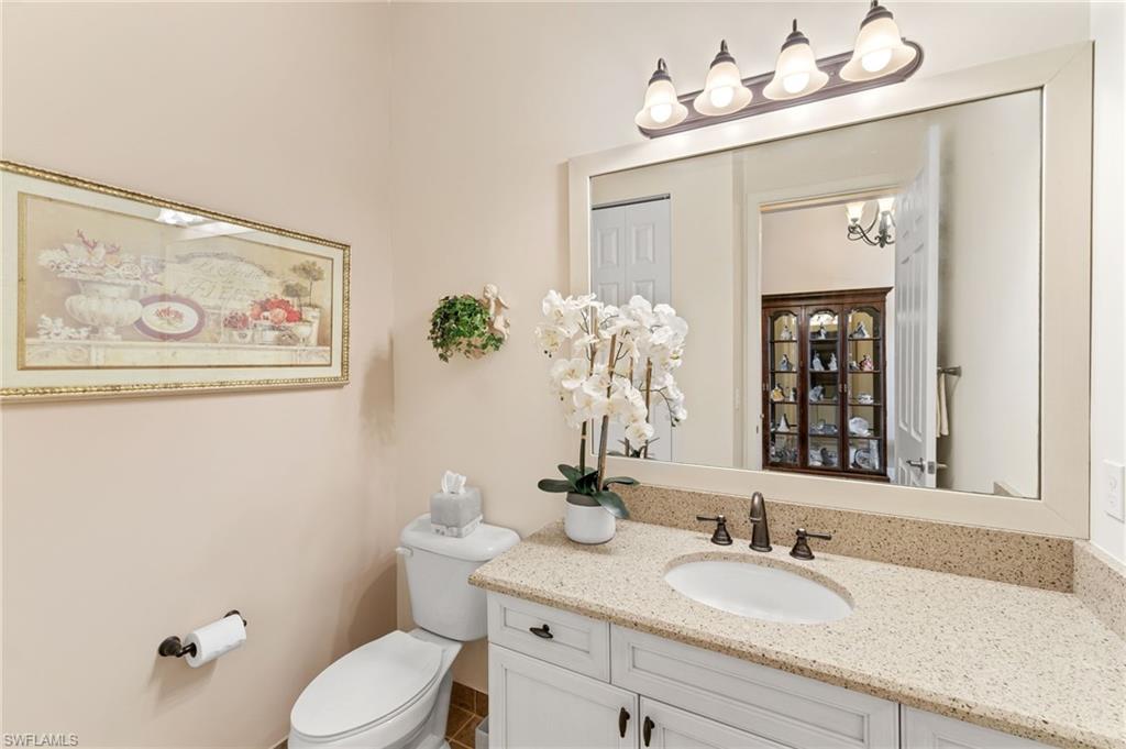 4339 Aurora Street Naples, FL 34119 - Photo 30 of 47 a bathroom with a sink vanity granite and toilet
