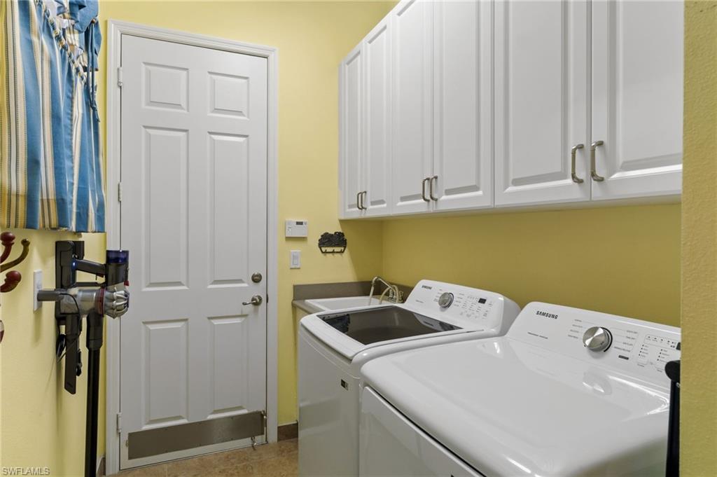 4339 Aurora Street Naples, FL 34119 - Photo 35 of 47 a utility room with dryer and washer