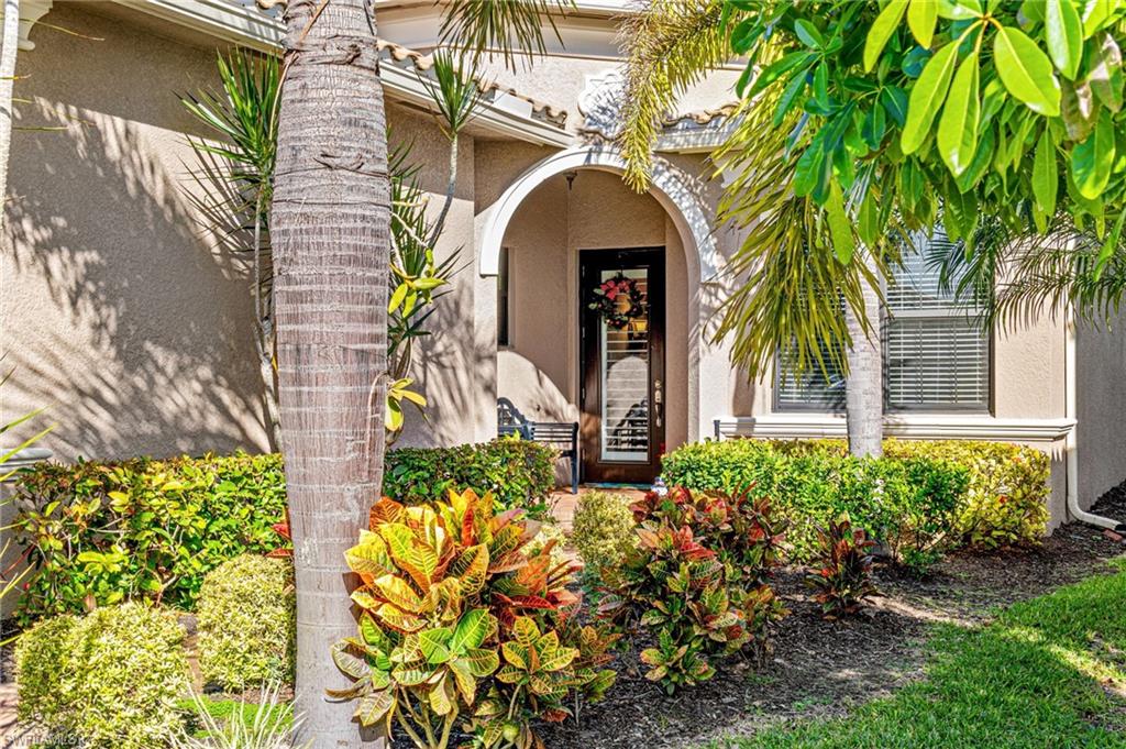 4339 Aurora Street Naples, FL 34119 - Photo 36 of 47 a front view of a house with a garden