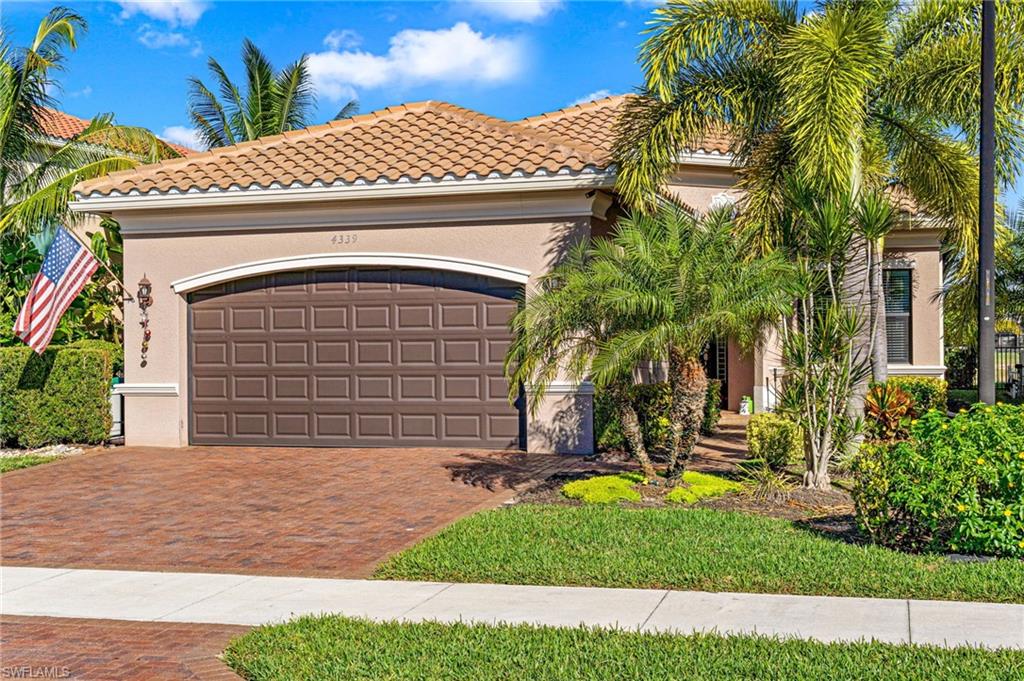4339 Aurora Street Naples, FL 34119 - Photo 37 of 47 a front view of a house with a yard