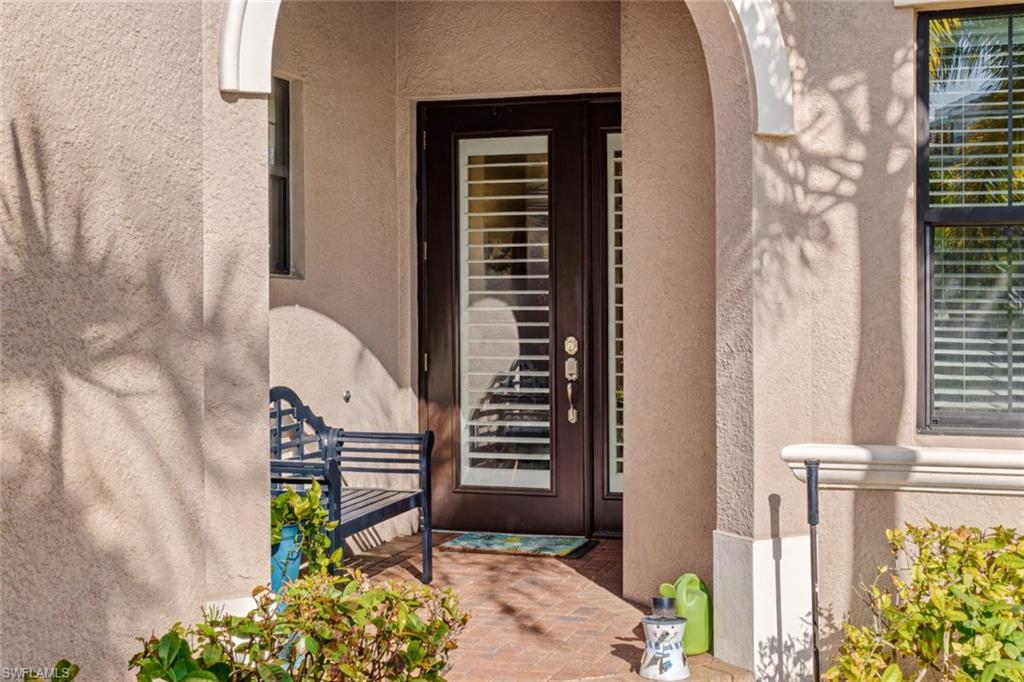 4339 Aurora Street Naples, FL 34119 - Photo 4 of 47 a view of a balcony with wooden floor and a potted plant